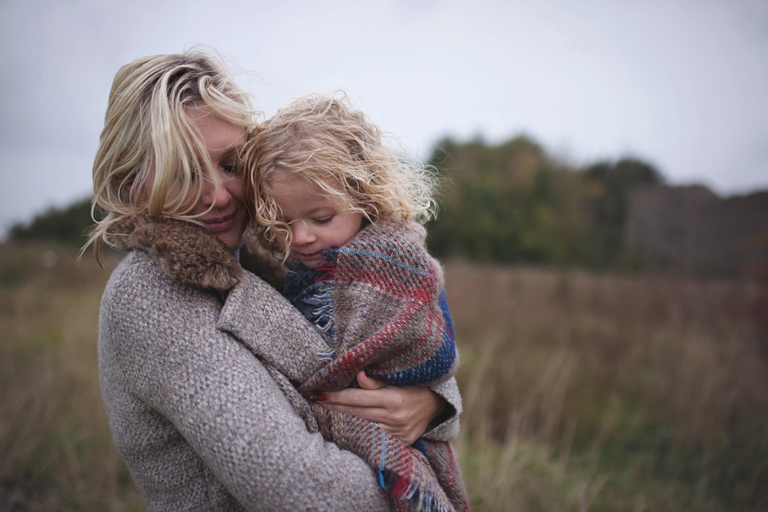 Exist in your photographs image of mum cuddling young daughter by Moira Lizzie Photography