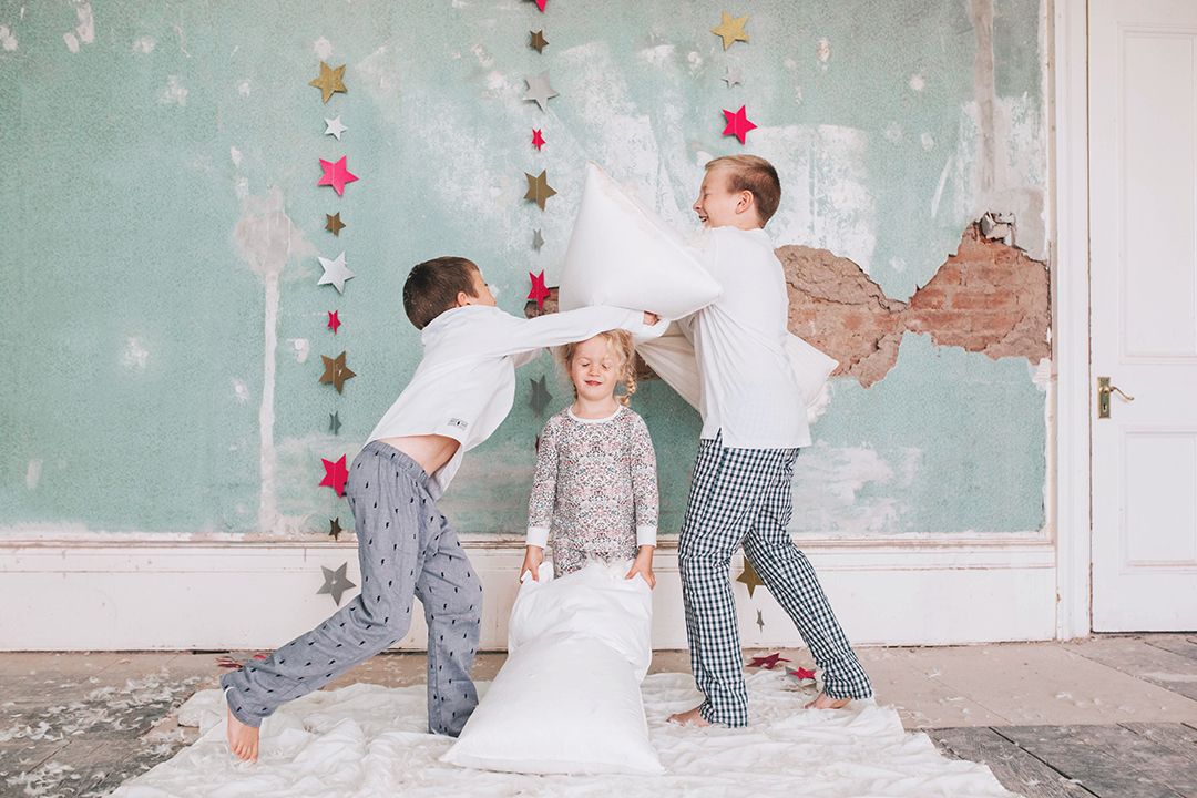 Sibling pillow fight at home