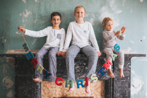 Siblings with Christmas banner