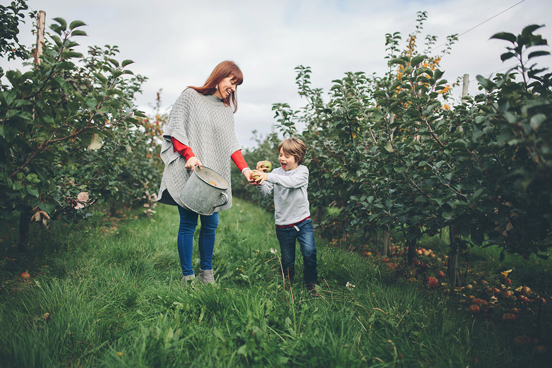 Exist in your photographs image of mum in apple orchard with son by Moira Lizzie Photography