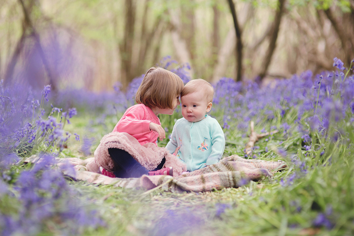 Sisters in bluebells as seen on Moira Lizzie Photography client referral webpage